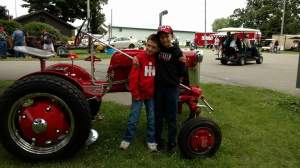 Little Bear and Rockstar posing with the favorite tractor of Day 1.